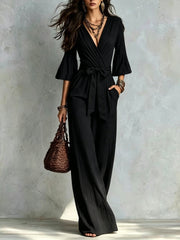 Damen Jumpsuit Wickel-Optik mit weitem Bein, Taillengürtel und Glockenärmeln Nord Taschen – Schwarz